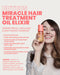Nainen pitelee ELEVEN Australia Miracle Hair Treatment Oil Elixir -hiusöljyä
